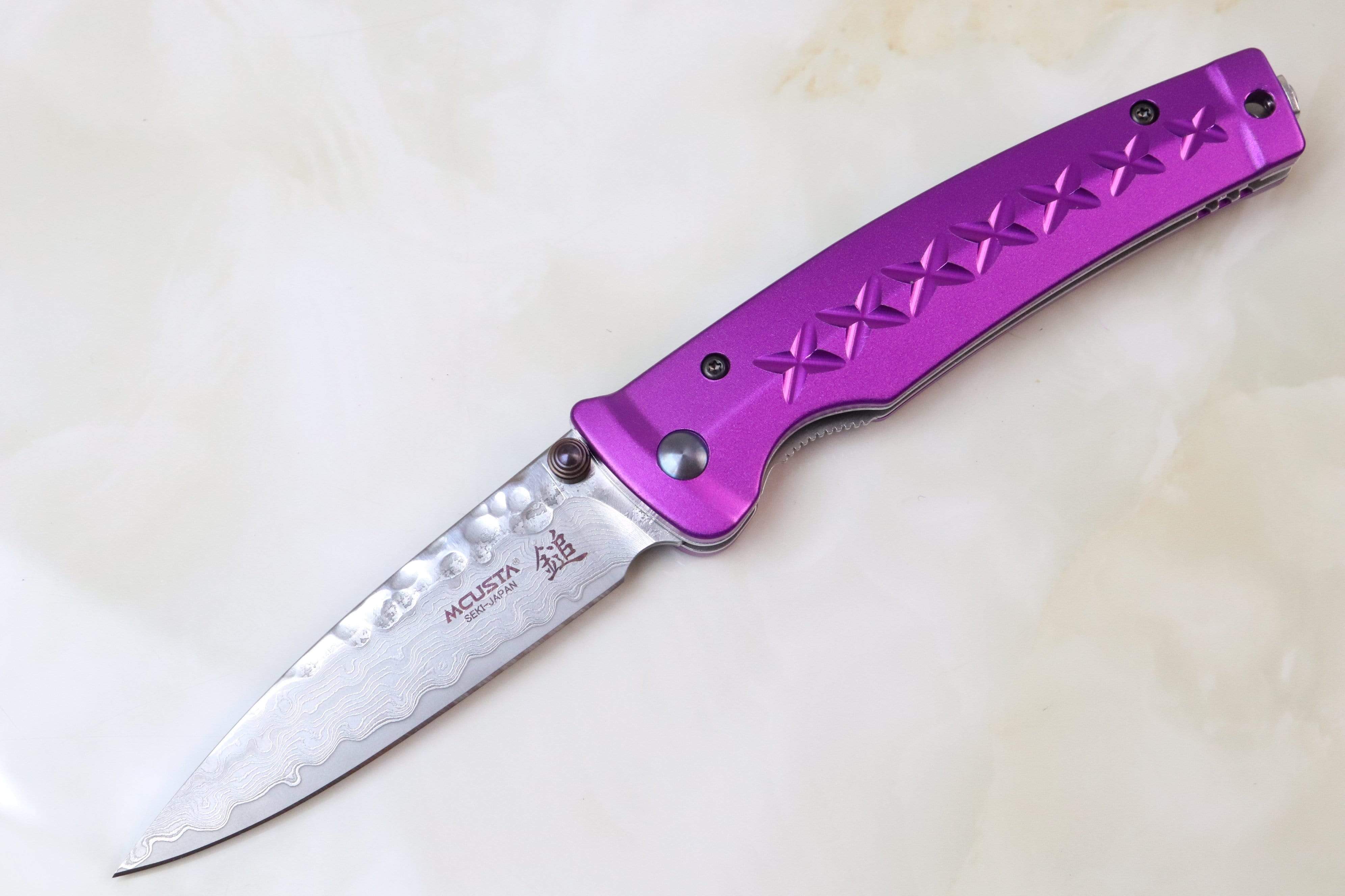 https://japaneseknifedirect.com/cdn/shop/products/mcusta-fusion-series-mc-162d-vg-10-tsuchime-hammered-damascus-purple-17218885976109.jpg?v=1599606803